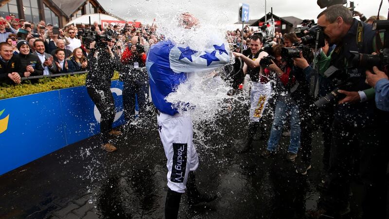 Ruby Walsh is soaked by buckets of water thrown by fellow jockies. Photograph: Tommy Dickson/Inpho