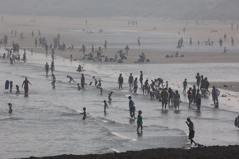 Scores of people dip their dips into the water at Portmarnock during the hot weather. Photograph: Nick Bradshaw/The Irish Times