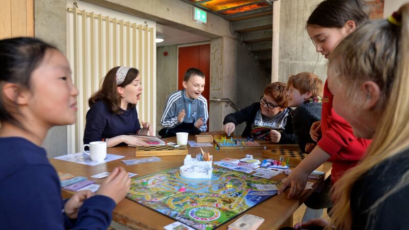 Anna Carey playing board games with children in The Ark, Fionnán O’Baoighill, Sean Cannon and Finn O’Donaill, and (foreground) Amia Zheng, Freya Simpson and Amalia Godley. Photograph: Alan Betson/The Irish Times