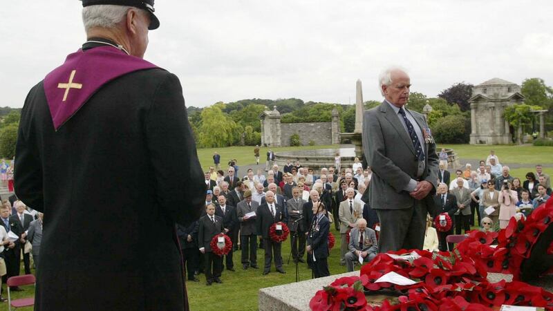 Naval chaplain friar Des Campion looks on as former major Sean Murphy salutes fallen comrades at the D-Day service held at the Irish National War Memorial, Dublin. Photograph:  Gareth Fuller /PA Images via Getty Images
