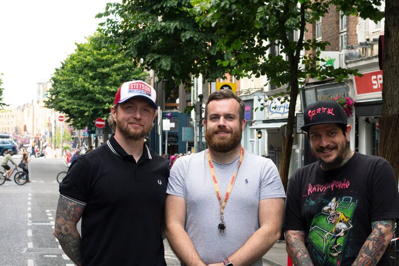 (L-R) Adrian Borowski, owner of Reinkarnated, Paul Keville, owner of Stoned and Gabriel Lemos, tattoo artist at Reinkarnated stand on Parliament Street as the street is pedestrianised on Friday and Saturday nights in August 2022.