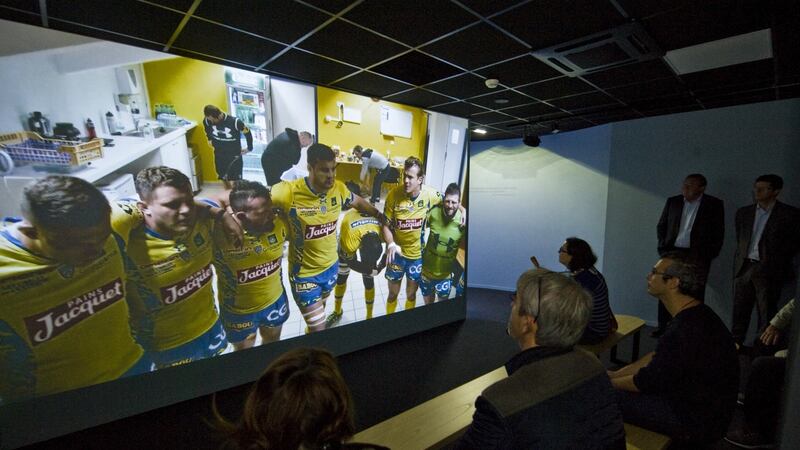 Reporters watch an audiovisual presentation at the Clermont Museum at Stade Marcel Michelin.