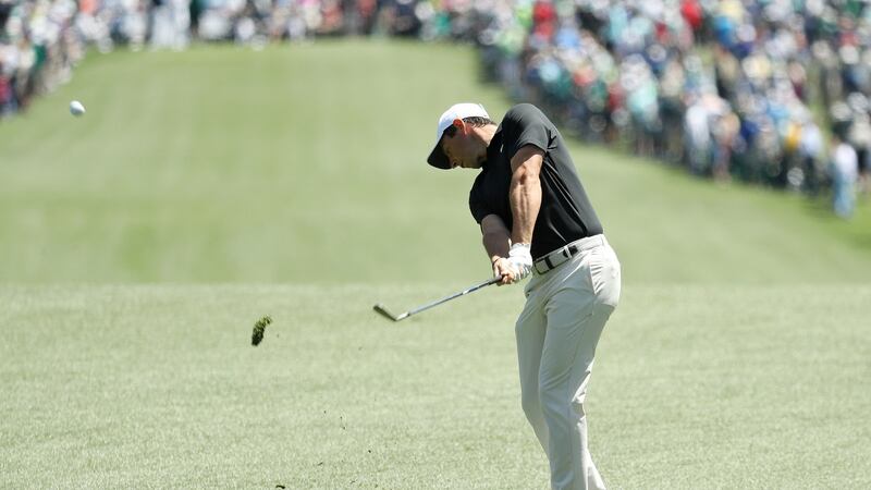 McIlroy plays his second shot on the first hole. Photo: Patrick Smith/Getty Images