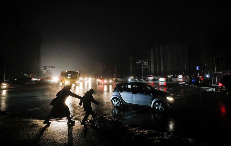 People cross a dark street in Kyiv on November 24th amid ongoing blackouts as a result of Russia's invasion. Photograph: Sergey Dolzhenko/EPA-EFE