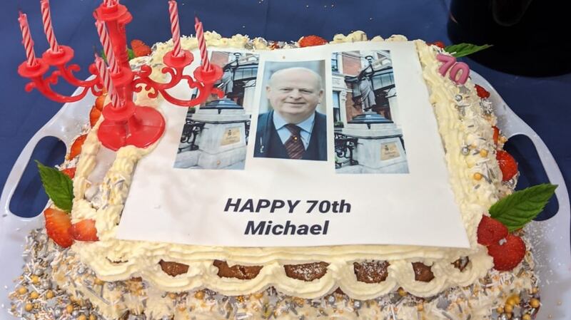 Michael McDowell 70th birthday cake featured a picture of him flanked by the statues of Nubian princesses outside the Shelbourne Hotel which he  had campaigned to have reinstated