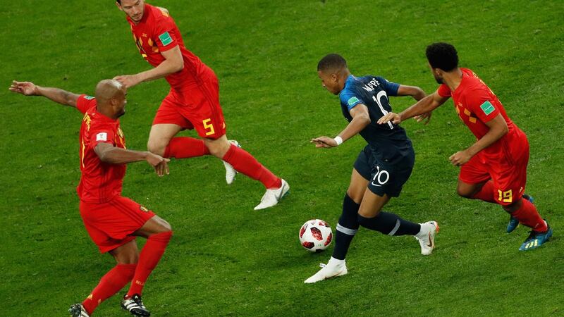 France’s forward Kylian Mbappé takes on all comers during France’s World Cup semi-final victory over Belgium in Saint Petersburg on Tuesday. Photograph: Adrian Dennis/AFP/Getty Images