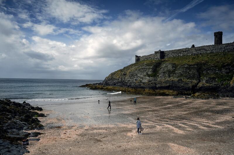 A beach beneath the imposing ruins of Peel Castle on the west coast of the Isle of Man in September. Photograph: Mary Turner/The New York Times