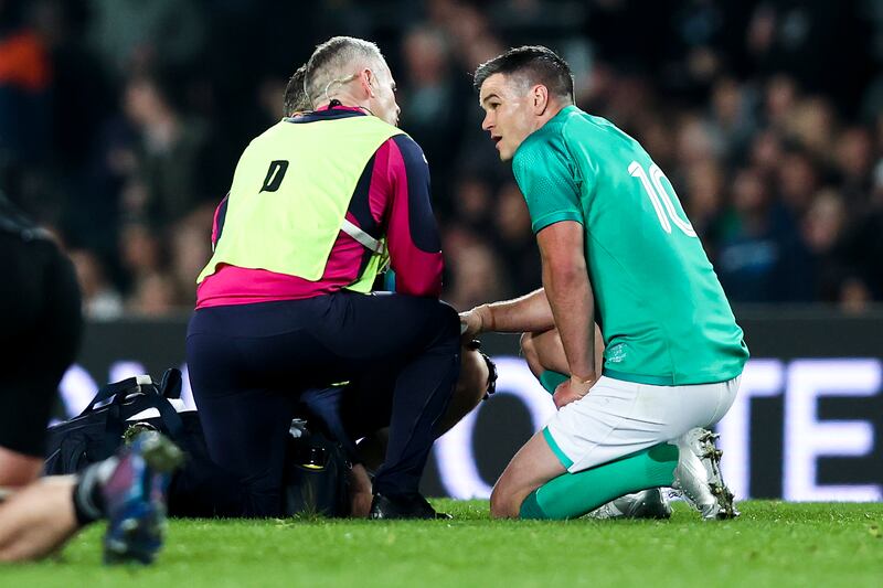 Johnny Sexton receives medical attention during Ireland's first Test defeat at Eden Park. Photograph: Phil Walter/Getty Images