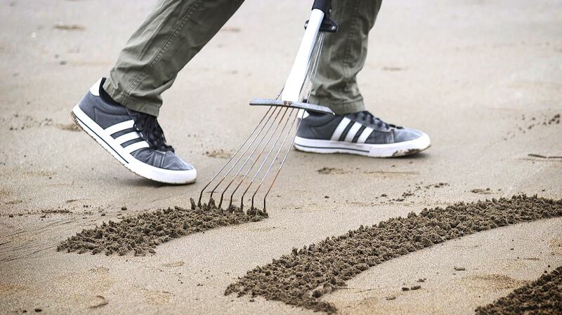 'The tidal sand contains a lot of moisture underneath, so it is bright. When I rake, it brings wetter, darker sand to the surface, and that creates a contrast.' Photograph: Bryan O’Brien