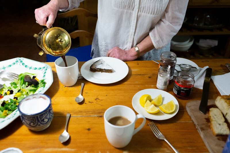 Roden serving coffee alongside a slice of sugar-sprinkled walnut cake, a recipe from Claudia Roden’s cookbook Med. Photograph: Lauren Fleishman/New York Times