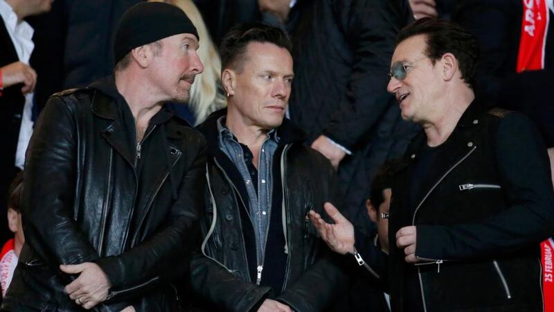 U2 band members   Edge, Larry Mullen and Bono in the crowd at the Louis II Stadium for the  Champions League round of 16 second leg match between Monaco and Arsenal. Photograph: Eric Gaillard/Reuters