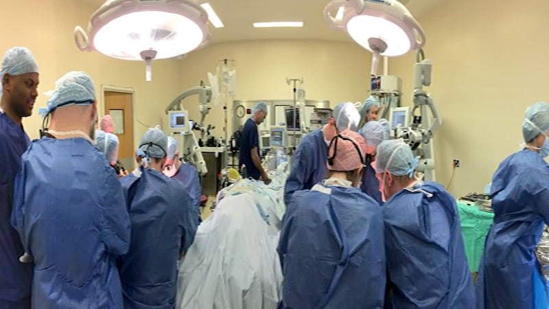 A handout photo issued by Leeds Teaching Hospitals NHS Trust of Consultant Plastic Surgeon Professor Simon Kay  and his team as they perform the UK’s first double hand transplant at Leeds General Infirmary on Chris King. Photograph: PA