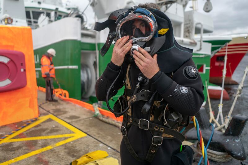 David McGloin, commercial diver, prepares his equipment for entering the water at the pier in Killybegs, Co Donegal. His crew is cleaning the propellers of a fishing boat. Photograph: Chris Maddaloni/The Irish Times