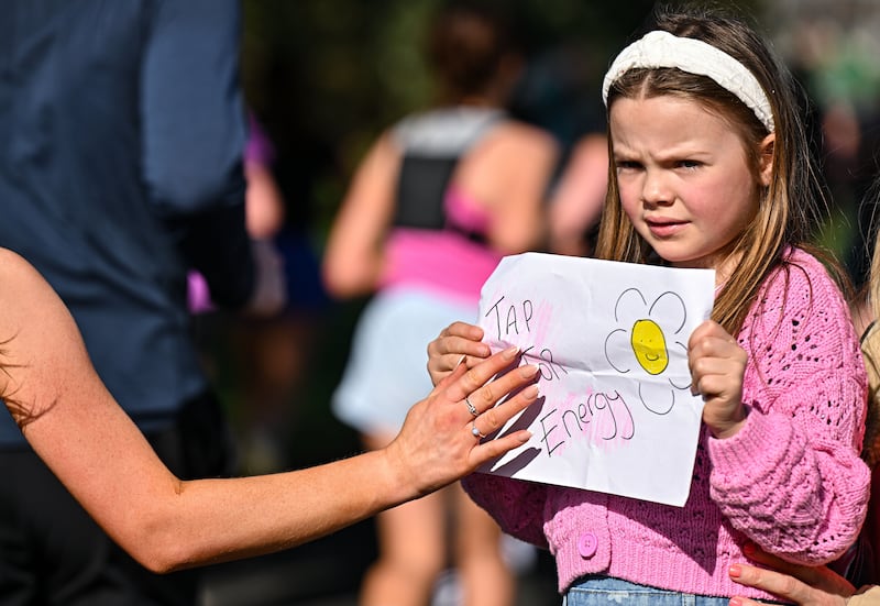 Daisy McGeady (six) offers runners some much-needed energy for the final few miles in Clontarf. Photograph: Sam Barnes/Sportsfile