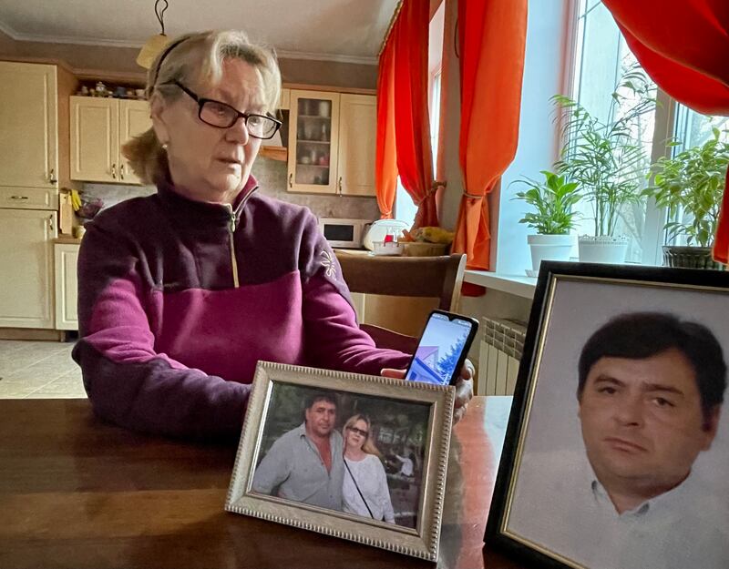Liudmyla Kizilova with photographs of husband Valeriy, who was killed by Russian troops when they occupied Bucha a year ago. Photograph: Daniel McLaughlin