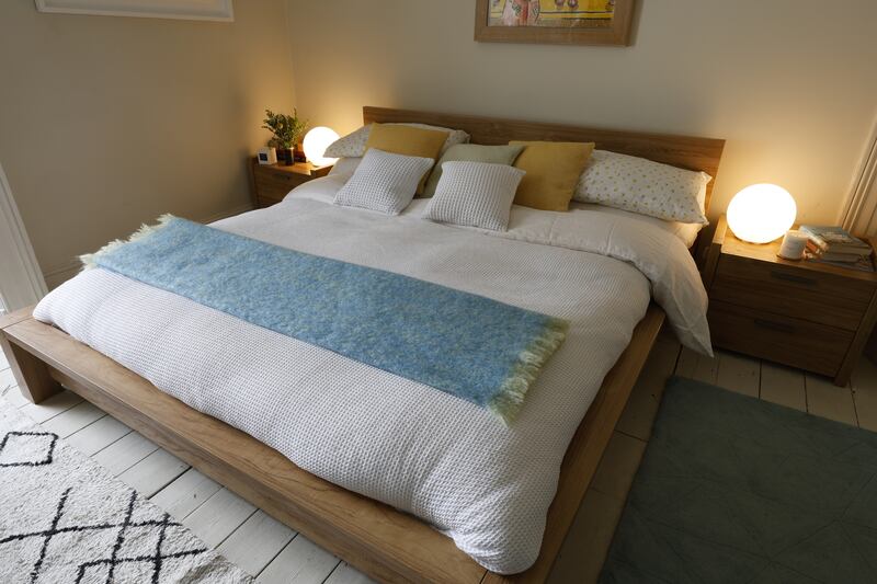 Helen McAlinden’s guest bedroom with linen white Lumi print, waffle bedspread and Foxford cushions. Photograph: Nick Bradshaw