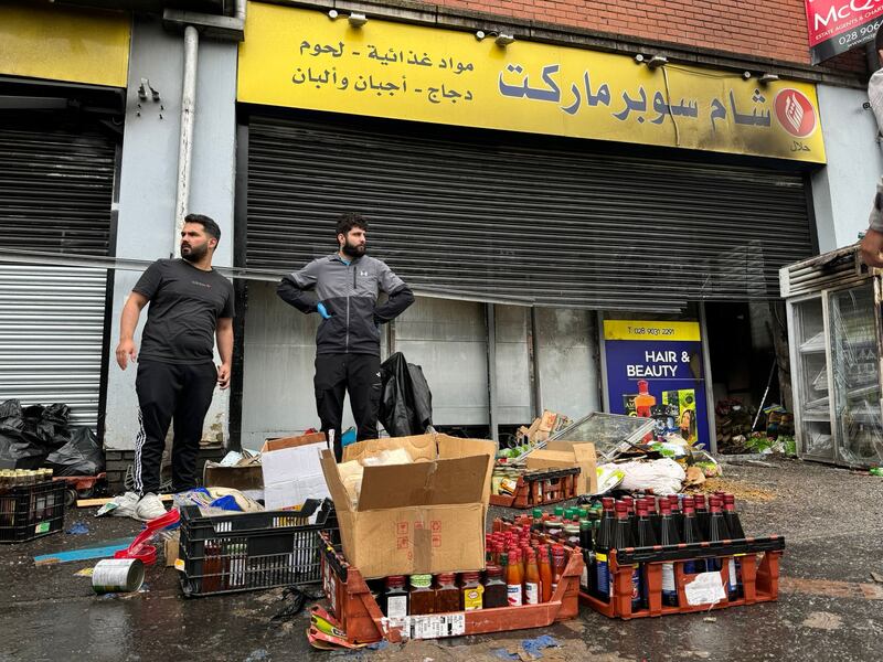 Syrian shop owner Abdelkader Al Alloush counts the cost of damage to his shop in Sandy Row in south Belfast after rioting in the area. Photograph: Pacemaker