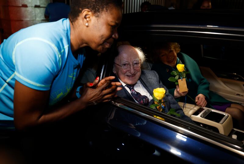 Monica Pumpkin of the Sanctuary Runners presented flowers to Michael D Higgins and his wife Sabina as they departed Áras an Uachtaráin on Monday evening. His second seven-year term ends at midnight. Photograph: Nick Bradshaw