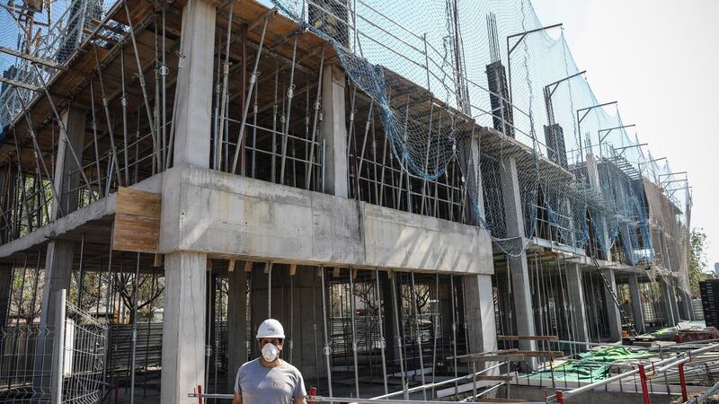 A worker  wearing a  face mask on a construction site in Barcelona, Spain. Photograph: Bloomberg