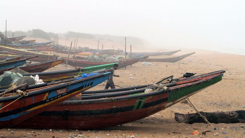 A fisherman runs during  severe winds at the coastal line at Konark in Puri district on the eve of cyclone Fani’s landfall in Odisha coast in India. Photograph: EPA/STR