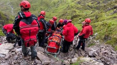 Members of Kerry Mountain Rescue Team carry an injured person on a stretcher down the ‘Devil’s Ladder’ from Carrauntoohill