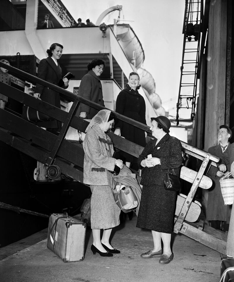 Beatrice Blyth of the Liverpool Vigilance Association - an anti-vice group - meets Ann Hughes (18), Noreen Byrne (18), Rose Maguire (19), and Irene Mullen (19), all from Dundalk, Co Louth, in 1958. The four were bound for London to train to be nurses. Photograph: Charlie Owens/Mirrorpix/Getty Images