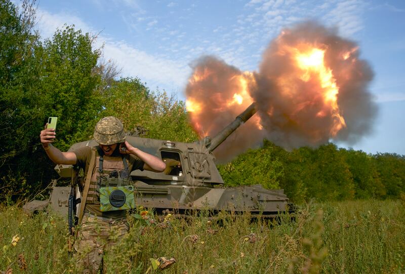 A Ukrainian soldier takes a selfie as an artillery system fires on the front line in Donetsk region, eastern Ukraine. Photograph: Kostiantyn Liberov/AP