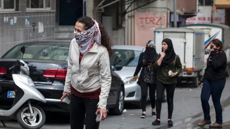 Masked female protesters hold stones during clashes with police in Okmeydani neighbourhood in Istanbul, Turkey. Istanbul went into a security lockdown on Friday as thousands of police manned barricades and closed streets to stop May Day rallies at Taksim Square, a symbolic point for protests. Photograph: Kemal Aslan/Reuters