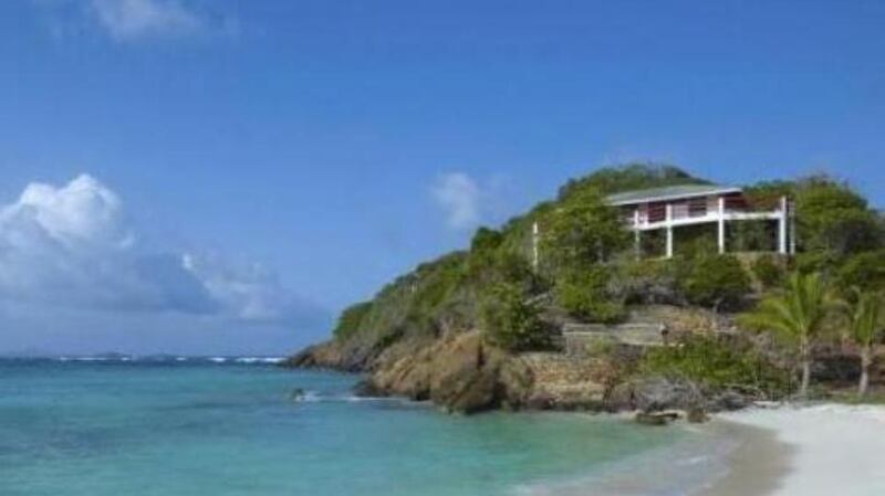 This two-bedroom, two-bathroom house sits 25ft above a swimming beach replete with white sand and coral reefs.