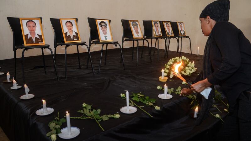 A woman offers  flowers  during a memorial ceremony in Addis Ababa for seven Ethiopian Airlines  crew members who died in  a Boeing 737 Max 8 plane crash at the weekend. Photograph: AFP/Getty