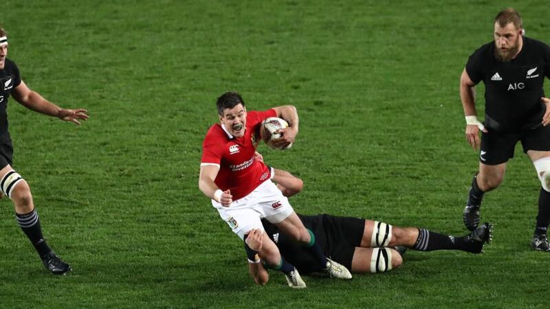 Johnny Sexton of the Lions is tackled by Sam Whitelock. Photograph: David Rogers/Getty Images