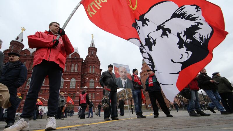 A supporter of Russian Communist Party holds a flag with portrait of Soviet Union leaders Vladimir Lenin and Joseph Stalin in Moscow earlier this month. Photograph: Konstantin Zavrazhin/Getty