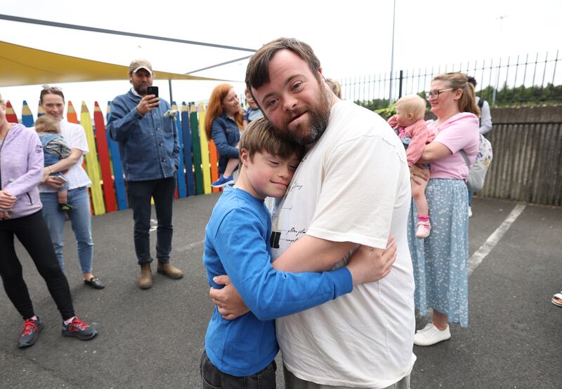 Martin is hugged by Milo O'Brien (11) from Whitehall, Dublin, at the Down Syndrome Centre in Sandyford in May. Photograph Nick Bradshaw
