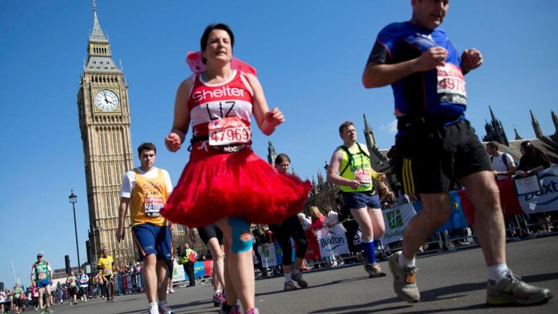 Participants run past the Houses of Parliament  during the London Marathon. Photograph: Reuters/Neil Hall