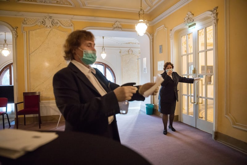 Socially distanced concert: staff disinfect door handles at the theatre in Wiesbaden. Photograph: Gordon Welters/NYT