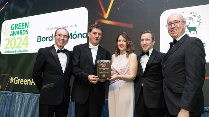 Ken Stockil, chief executive, 20Fifty Partners and Minister Eamon Ryan, presents the green transformation award to Louise Byrne and team
