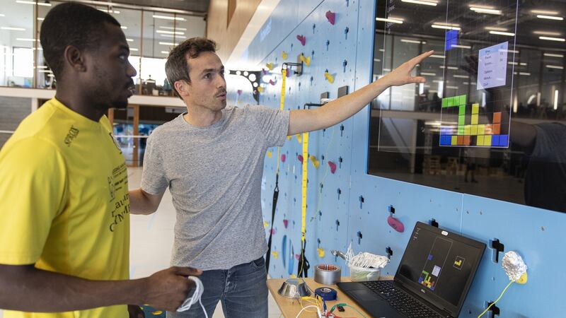 Joktan Willem (R) a teacher at the Sports Innovation Campus in Bruges, Belgium, shows Nehemie Kasongay Diakiesse how to create video games that get users to exercise. Developers are offering a physical twist to keep traditional fans interested and draw new ones who are bored with their workouts. Photograph: Ilvy Njiokiktjien/The New York Times