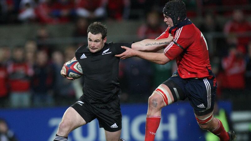 Munster’s Billy Holland tackles New Zealand’s Alby Mathewson during the game at Thomond park in 2008. Photograph: Billy Stickland/Inpho