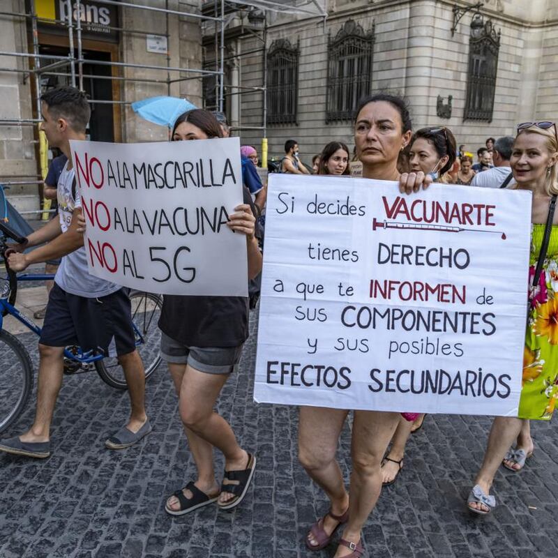 Anti-vaccine and anti-mask protesters displaying placards during protest.Photograph: Paco Freire/SOPA Images/LightRocket/Getty