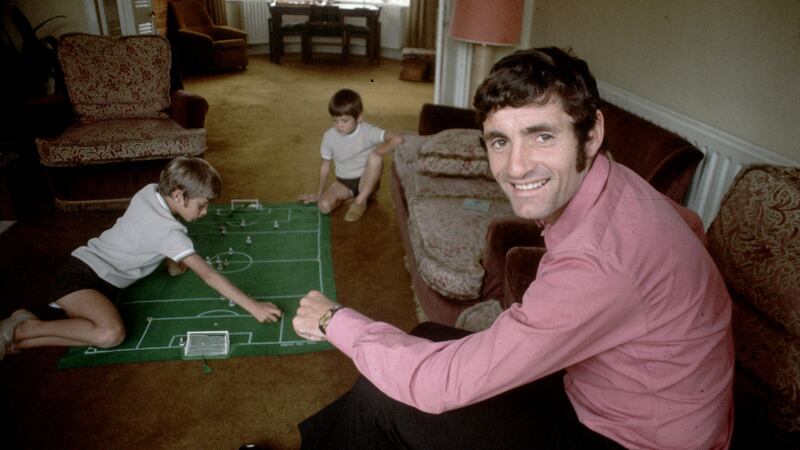 Arsenal footballer Frank McLintock at home watching his children playing the football game Subbuteo. Photograph: Express/Express/Getty Images