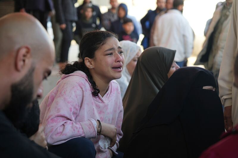 Relatives mourn next to the body of a Palestinian killed in the Israeli bombardment of the Gaza Strip at Al-Aqsa Hospital in Deir al-Balah. Photograph: Abdel Kareem Hana/AP