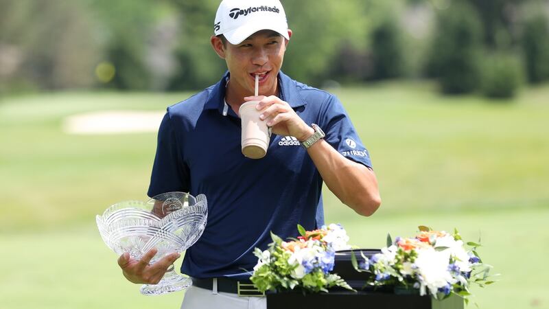 Collin Morikawa  celebrates with the winner’s trophy and a milkshake at the Workday Charity Open. Photograph:  Gregory Shamus/Getty Images