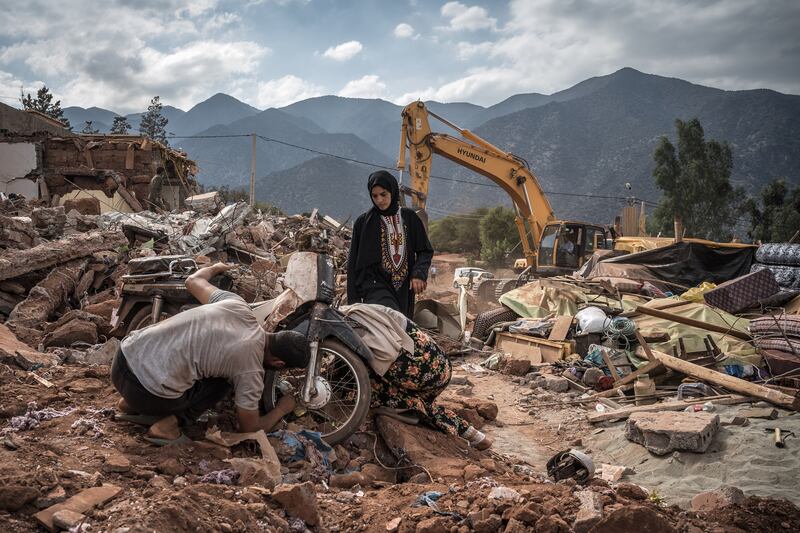 People try to repair a motorcycle while surrounded by debris from a destroyed building in Ouirgane, Morocco, on Tuesday, in the wake of the country's devastating earthquake. Photograph: Sergey Ponomarev/New York Times
                      