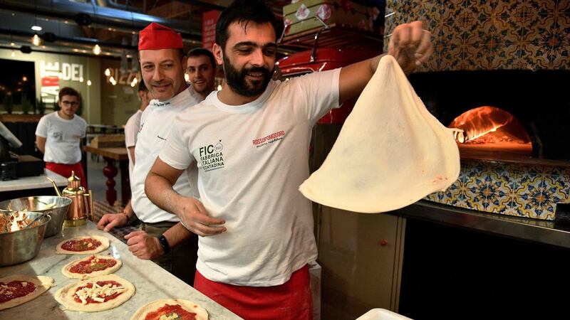 Pizza bakers prepare traditional pizza margherita  at Fico Eataly World agri-park in  Bologna, Italy, described as the Disneyland of Italian Food. Photograph: Vincenzo Pinto/AFP/Getty Images