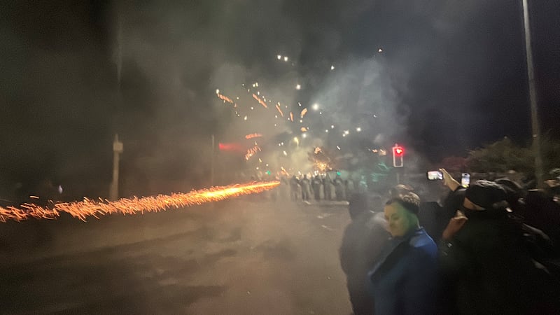 A firework launches at gardaí outside the hotel. Photograph: Niall Carson/PA Wire