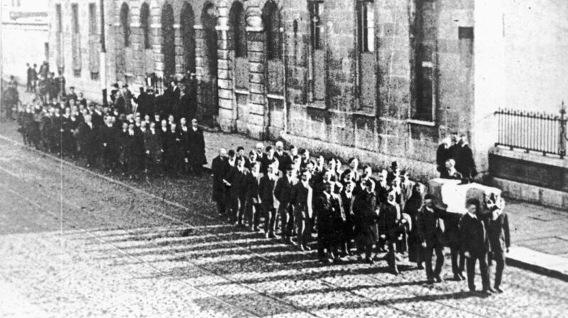 Circa 1920: Mourners walk behind a coffin at a funeral during the War of Independence in Ireland. Photograph:  Sean Sexton/Getty Images