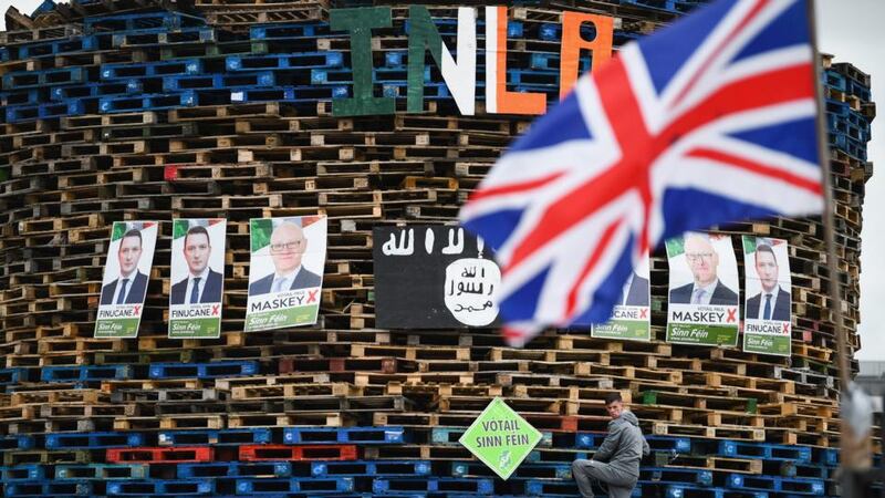 Twelfth of July bonfire: a loyalist climbs the Conway Street bonfire in Belfast. Photograph: Jeff J Mitchell/Getty