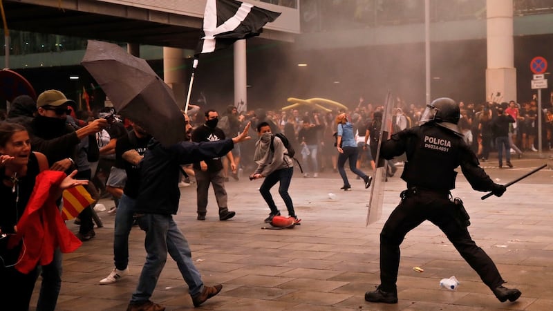 Riot policemen clash with protestors outside El Prat airport in Barcelona, Spain, on Monday. Photograph: Emilio Morenatti/AP