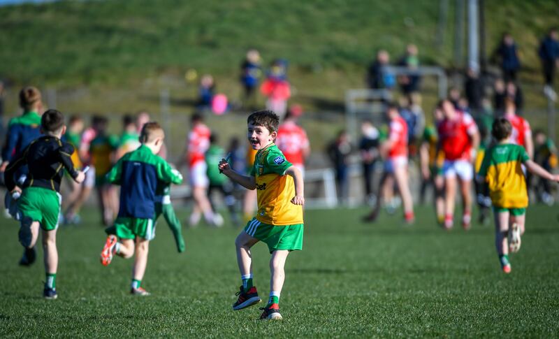 Children running onto the pitch at Ballyshannon after the game between Donegal and Louth. Photograph: Andrew Paton/Inpho