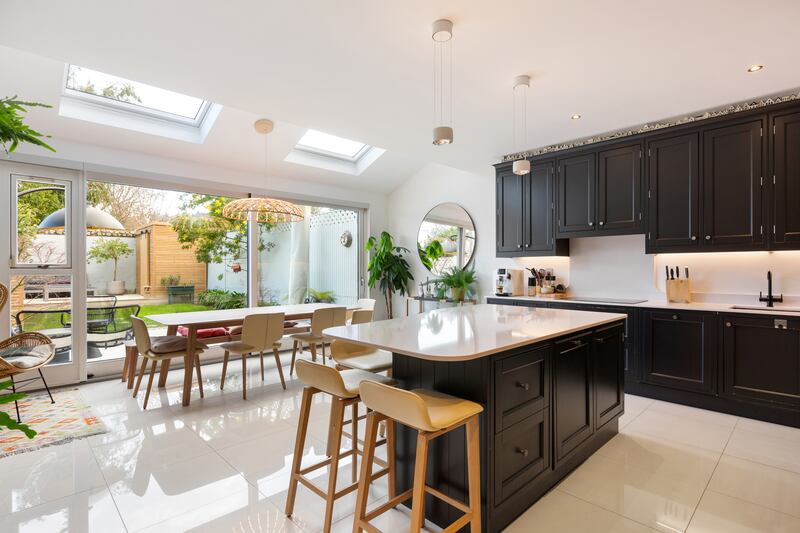 Kitchen and dining room lit by roof lights